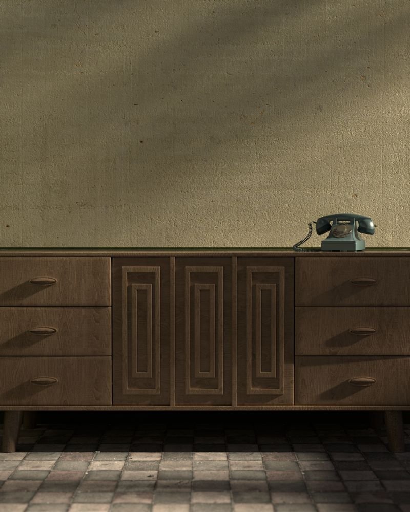 A long low sideboard with a rotary telephone resting on top